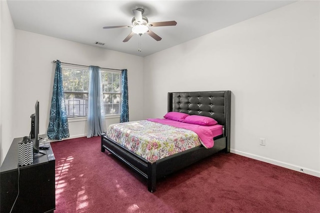 bedroom with dark colored carpet and ceiling fan