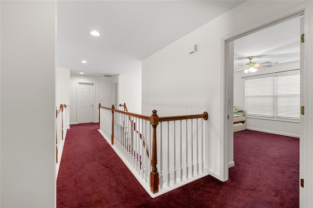 corridor with dark colored carpet