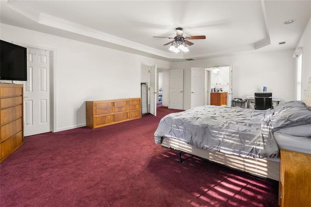 carpeted bedroom featuring crown molding, a tray ceiling, and ceiling fan