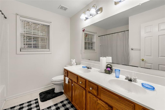 bathroom with vanity, tile patterned floors, toilet, and walk in shower