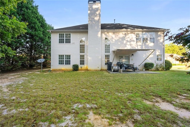 rear view of house with a yard and a patio area