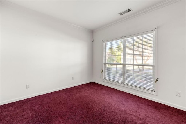 spare room featuring ornamental molding and carpet flooring