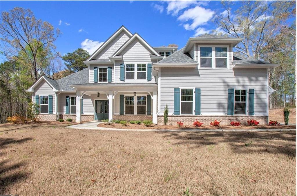 165 W Lake Blvd, Carrollton, GA 30116 - craftsman house featuring brick siding, a front yard, and roof with shingles