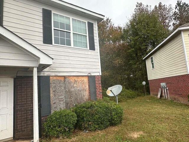 view of property exterior featuring a lawn