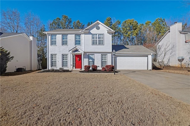 colonial inspired home featuring a garage, central AC, and a front yard