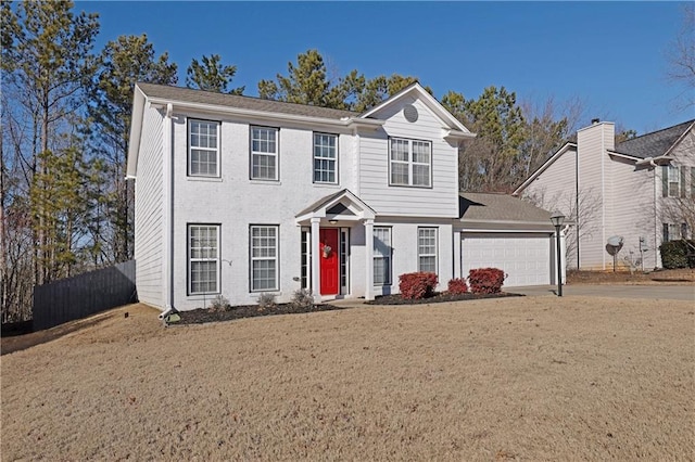 view of front of property featuring a garage and a front lawn