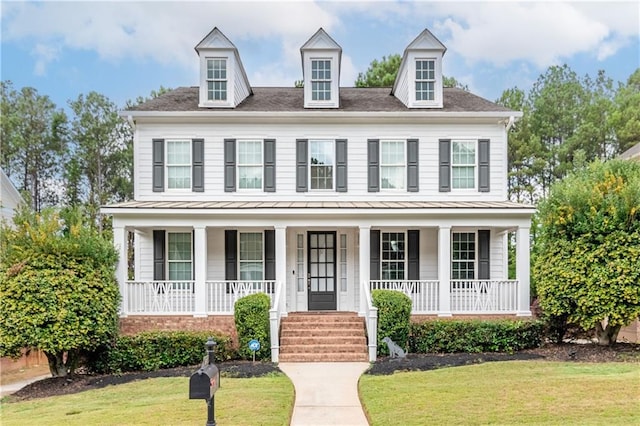 view of front of property with a porch and a front lawn