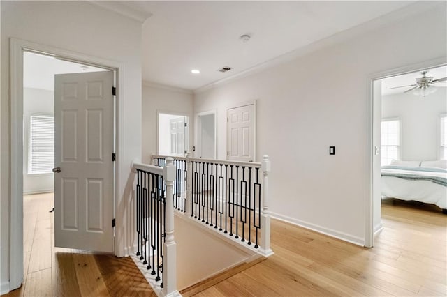 corridor featuring light hardwood / wood-style floors and ornamental molding