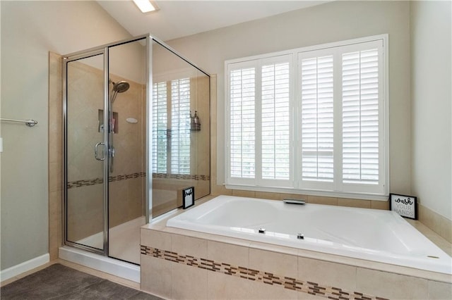 bathroom featuring plus walk in shower and vaulted ceiling