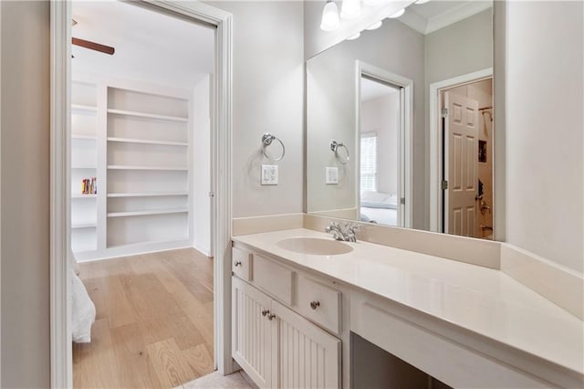 bathroom featuring wood-type flooring, vanity, and built in features