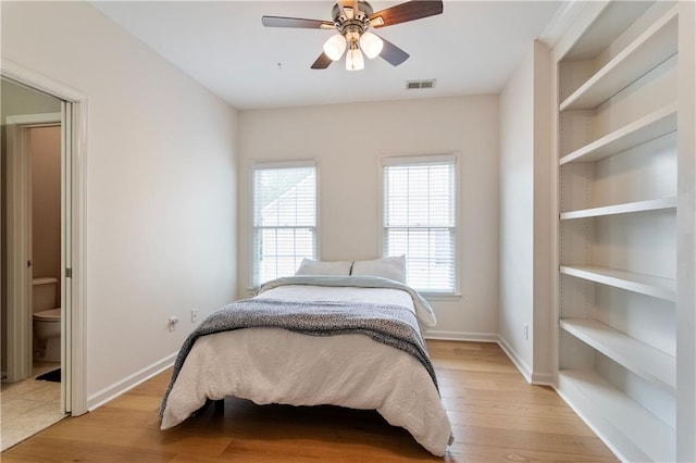 bedroom featuring multiple windows, light wood-type flooring, and ceiling fan