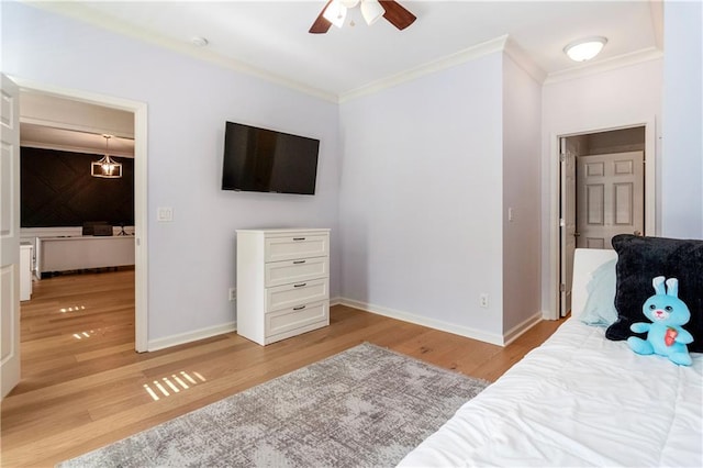 bedroom featuring light wood-type flooring, ceiling fan, and ornamental molding