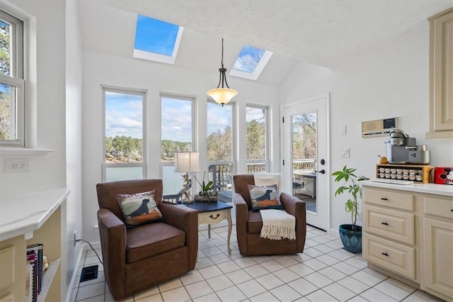 sunroom featuring lofted ceiling with skylight and a wealth of natural light