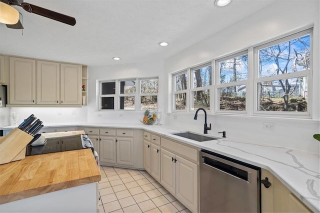 kitchen featuring open shelves, a sink, a textured ceiling, butcher block countertops, and dishwasher