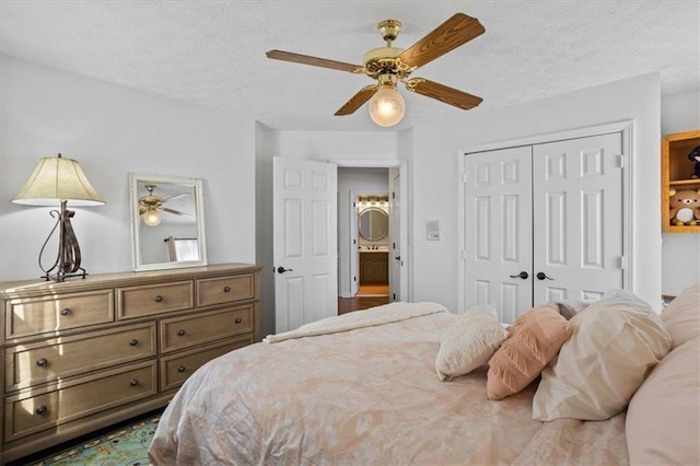 bedroom with a textured ceiling, a closet, and a ceiling fan