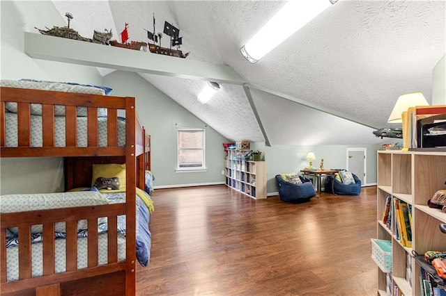 bedroom featuring vaulted ceiling, a textured ceiling, wood finished floors, and baseboards