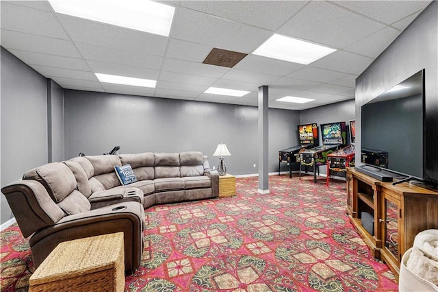 carpeted living room with a drop ceiling and baseboards