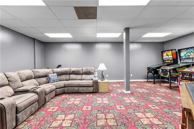 living room with a paneled ceiling and baseboards