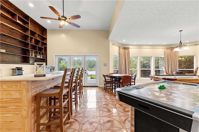 game room with french doors, recessed lighting, ceiling fan, a textured ceiling, and baseboards