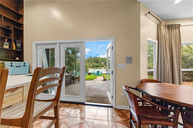 doorway to outside with a wealth of natural light, baseboards, and recessed lighting