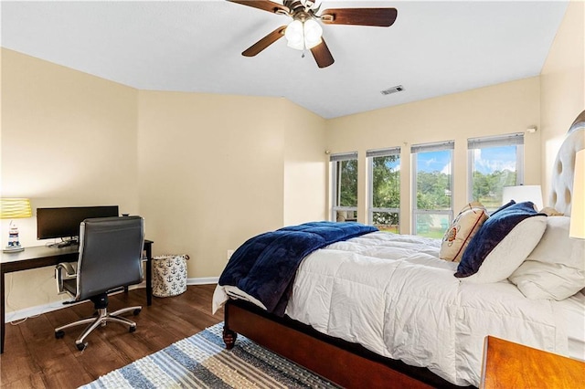 bedroom featuring a ceiling fan, wood finished floors, visible vents, and baseboards