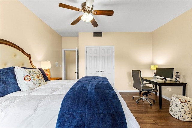 bedroom with a closet, visible vents, a ceiling fan, wood finished floors, and baseboards