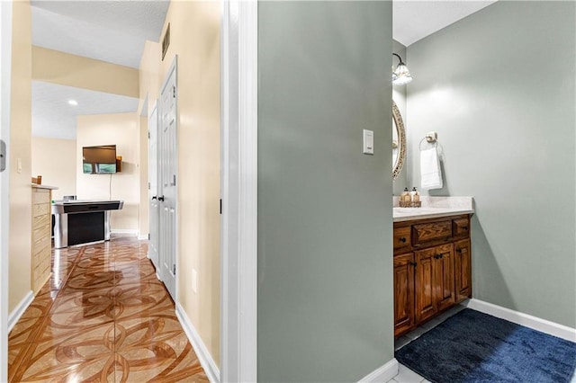 bathroom featuring baseboards and vanity