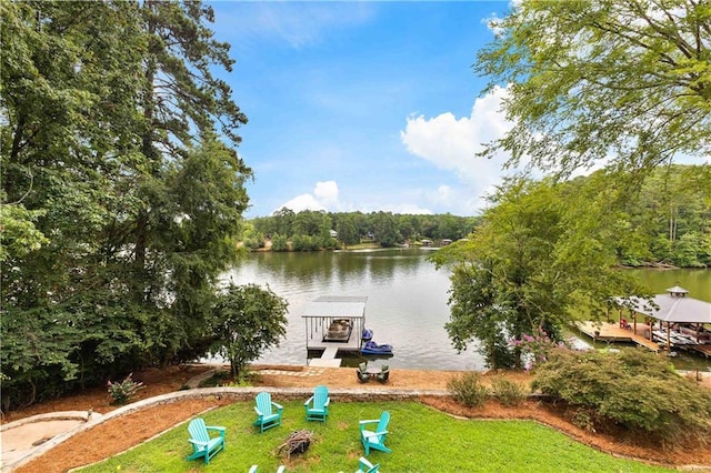 exterior space featuring an outdoor fire pit and a water view