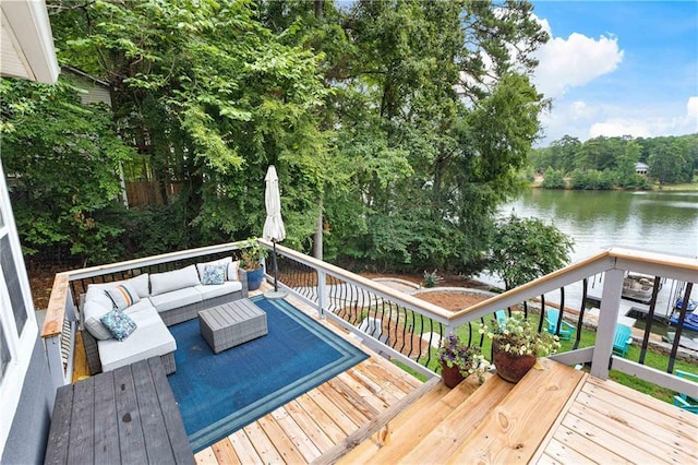 wooden terrace featuring a water view and outdoor lounge area