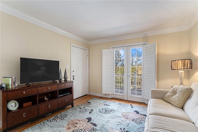 living room with wood-type flooring, french doors, and crown molding