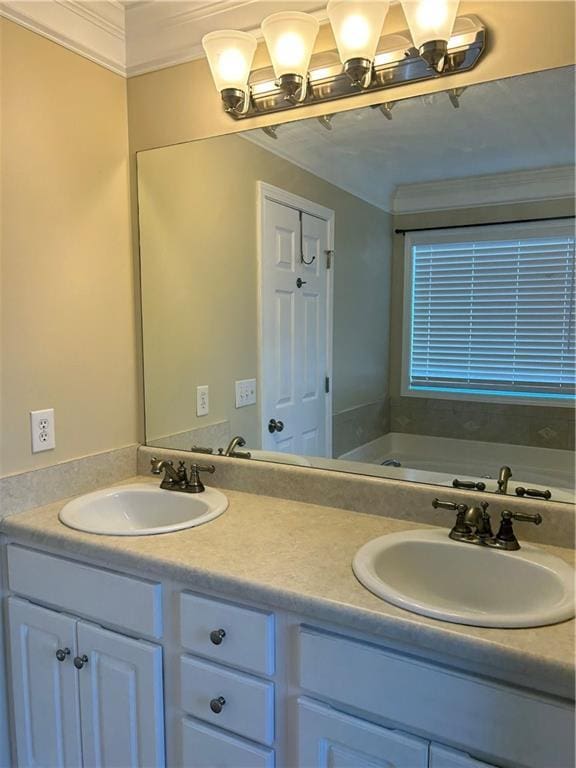 full bath with double vanity, a garden tub, ornamental molding, and a sink