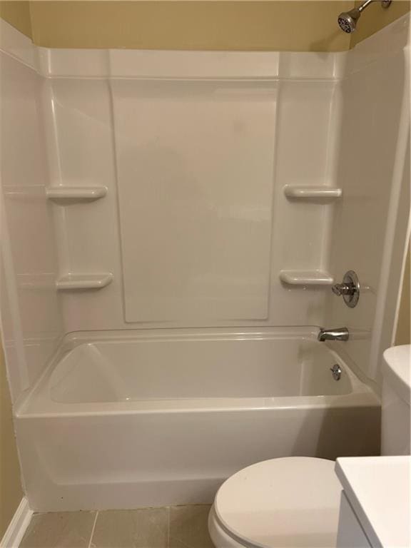 bathroom featuring washtub / shower combination, vanity, toilet, and tile patterned floors