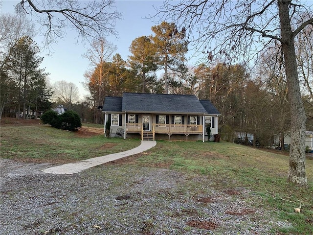 view of front facade with a front lawn and a shingled roof