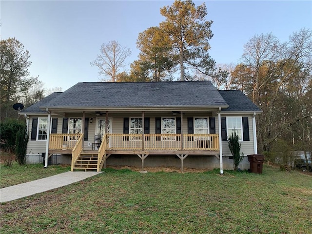 view of front of home with crawl space, a porch, a shingled roof, and a front yard