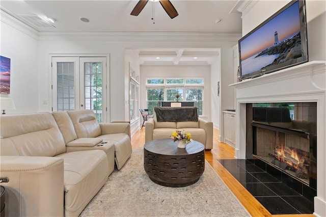 1003 Pearl Pt NE, Sandy Springs, GA 30328 - living room featuring a tiled fireplace, wood finished floors, a ceiling fan, and crown molding