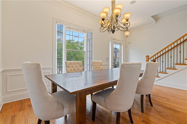 1003 Pearl Pt NE, Sandy Springs, GA 30328 - dining room featuring a chandelier, light wood-type flooring, ornamental molding, stairway, and wainscoting