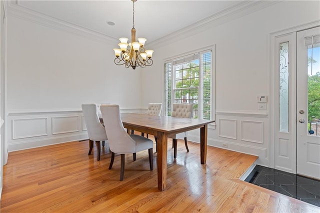 1003 Pearl Pt NE, Sandy Springs, GA 30328 - dining area with a chandelier, ornamental molding, healthy amount of natural light, light wood-type flooring, and a wainscoted wall