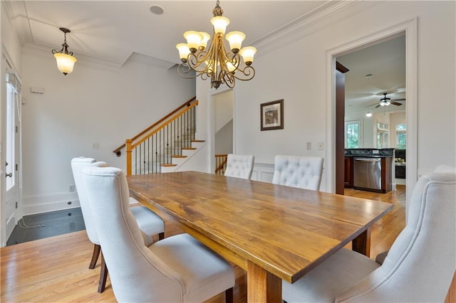 1003 Pearl Pt NE, Sandy Springs, GA 30328 - dining space featuring ornamental molding, a chandelier, wood finished floors, stairs, and a ceiling fan