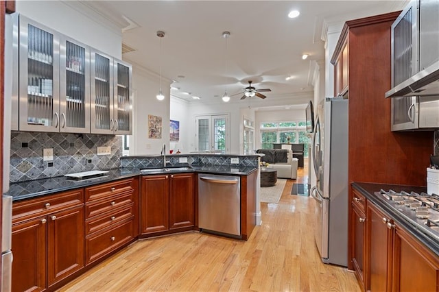 1003 Pearl Pt NE, Sandy Springs, GA 30328 - kitchen featuring appliances with stainless steel finishes, a sink, ornamental molding, wall chimney exhaust hood, and light wood finished floors