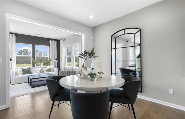 dining room featuring baseboards and wood-type flooring