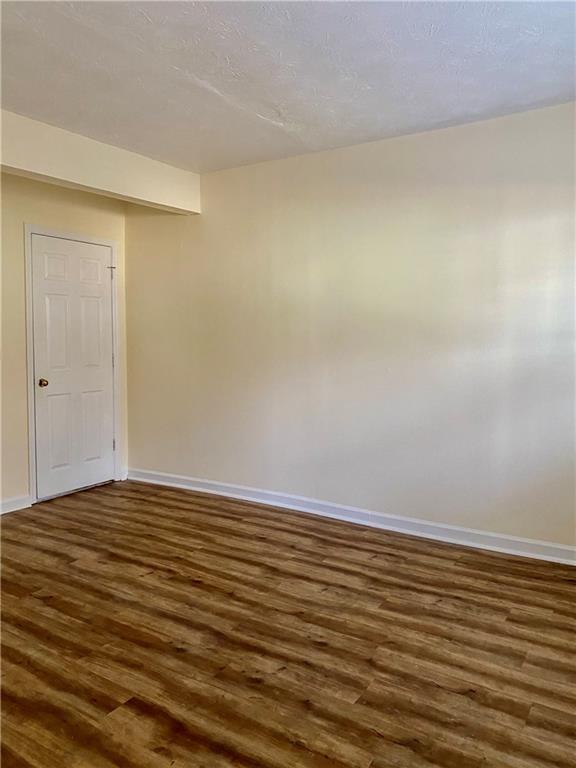 5105 N Bridges Dr, Alpharetta, GA 30022 - unfurnished room featuring dark wood-style floors and baseboards