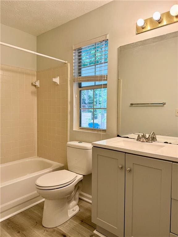 5105 N Bridges Dr, Alpharetta, GA 30022 - bathroom featuring wood finished floors, toilet, vanity, shower / bath combination, and a textured ceiling