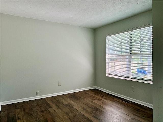 5105 N Bridges Dr, Alpharetta, GA 30022 - empty room featuring dark wood finished floors, baseboards, and a textured ceiling