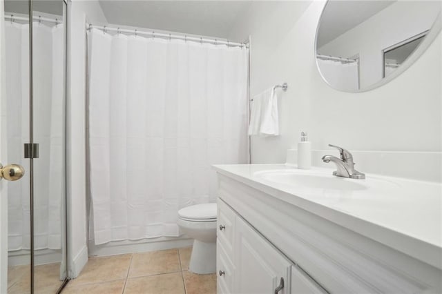 full bathroom featuring toilet, vanity, tile patterned floors, and shower / tub combo with curtain