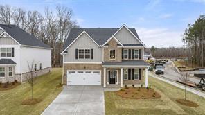 13917 Homer Ln, Covington, GA 30014 - traditional-style home featuring a garage, concrete driveway, and a front yard