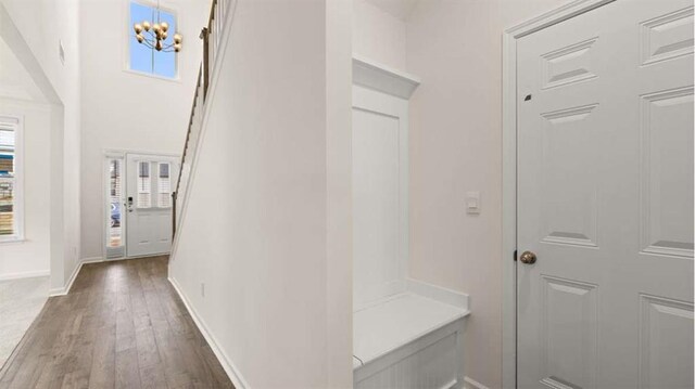 13917 Homer Ln, Covington, GA 30014 - mudroom featuring baseboards, wood finished floors, and an inviting chandelier