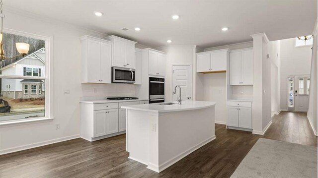 13917 Homer Ln, Covington, GA 30014 - kitchen featuring a sink, dark wood finished floors, black stovetop, stainless steel microwave, and white cabinets