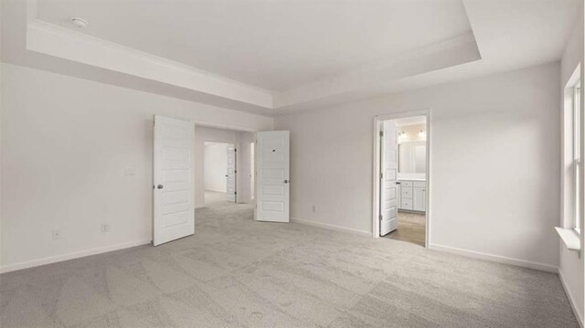 13917 Homer Ln, Covington, GA 30014 - unfurnished bedroom with baseboards, a tray ceiling, and carpet