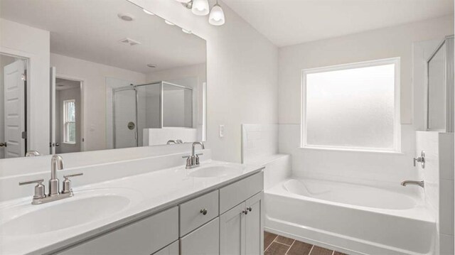 13917 Homer Ln, Covington, GA 30014 - bathroom with a stall shower, double vanity, a bath, and a sink