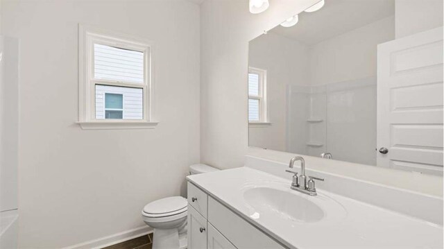 13917 Homer Ln, Covington, GA 30014 - bathroom with a tub to relax in, toilet, vanity, walk in shower, and baseboards